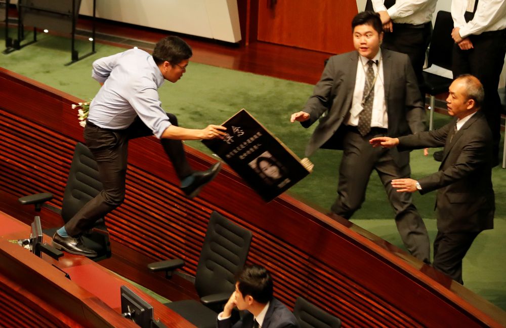 A lawmaker jumps on furniture as he tries to follow Hong Kongu00e2u20acu2122s Chief Executive Carrie Lam (not pictured), as Lam leaves the Legislative Council in Hong Kong, China October 17, 2019. u00e2u20acu201d Reuters pic