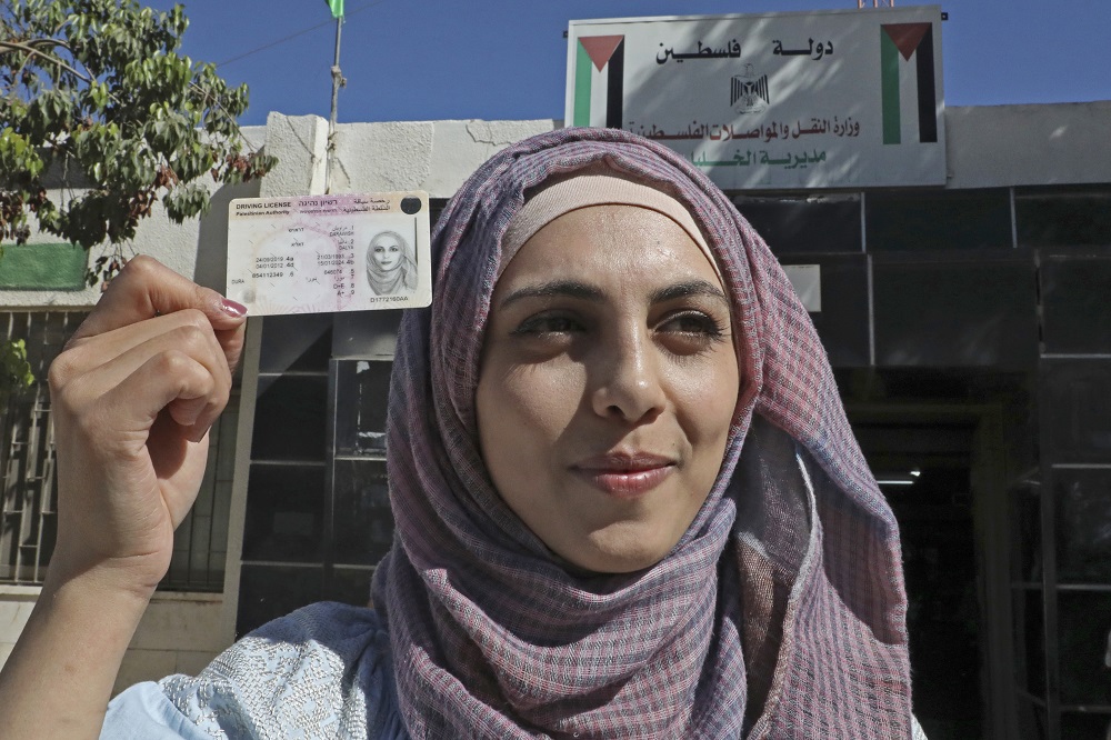 Palestinian Dalia al-Darawish holds her truck driveru00e2u20acu2122s license after passing her driving test, in the West Bank town of Hebron September 25, 2019. u00e2u20acu201d AFP pic