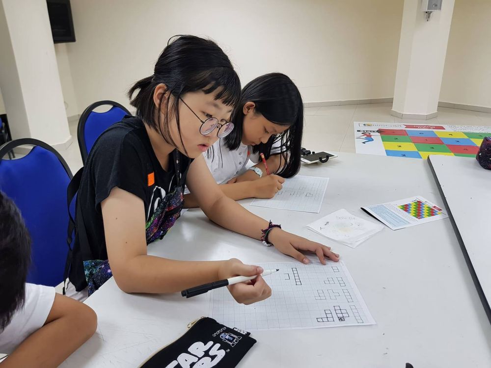 Some of the child participants at the Youth Festival working together to complete complex puzzles. — Picture courtesy of Malaysian Mensa Society
