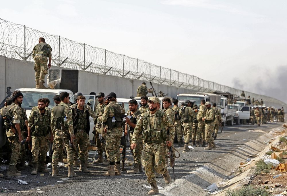 Pro-Turkish Syrian fighters gather along the Turkish side of the border as they prepare to take part in an offensive against Kurdish-controlled areas in north-eastern Syria launched by the Turkish military, on October 11, 2019. u00e2u20acu201d AFP pic