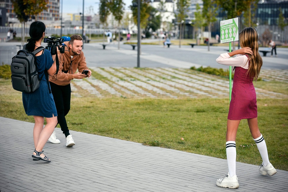 Russian child blogger Liza Anokhina (right), 12, participates in a shoot for her blog in a Moscow park September 13, 2019. — AFP pic  