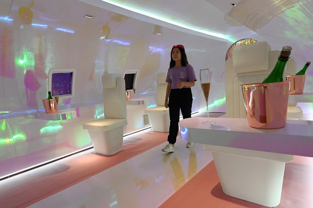 A crew member walks through an installation at The Bubble Tea Factory experience created by the El Masnou collective during a preview in Singapore October 15, 2019. — AFP pic