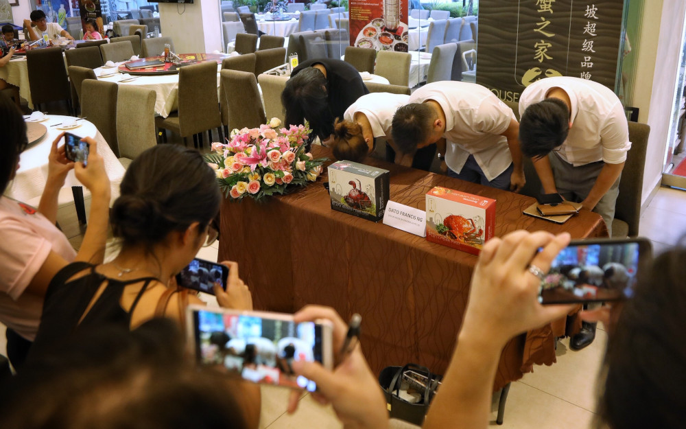 The House of Seafood management team apologising for putting live crabs in a claw machine. — TODAY pic