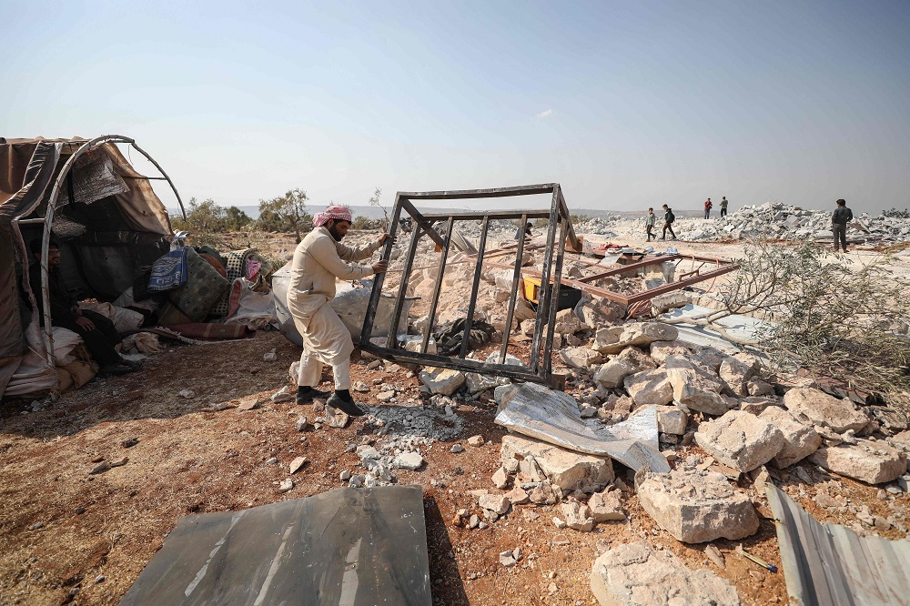 A Syrian man clears debris at the site of helicopter gunfire which reportedly killed nine people near the northwestern Syrian village of Barisha in the Idlib province along the border with Turkey on October 27, 2019. u00e2u20acu201d AFP pic   