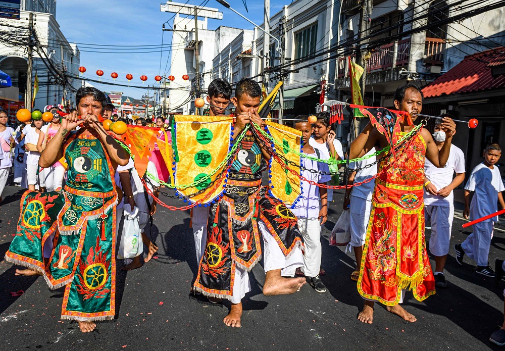 Devotees of a Chinese shrine with skewers pierced through their cheeks take part in a procession during the annual Vegetarian Festival in Phuket October 3, 2019. u00e2u20acu201d AFP pic         