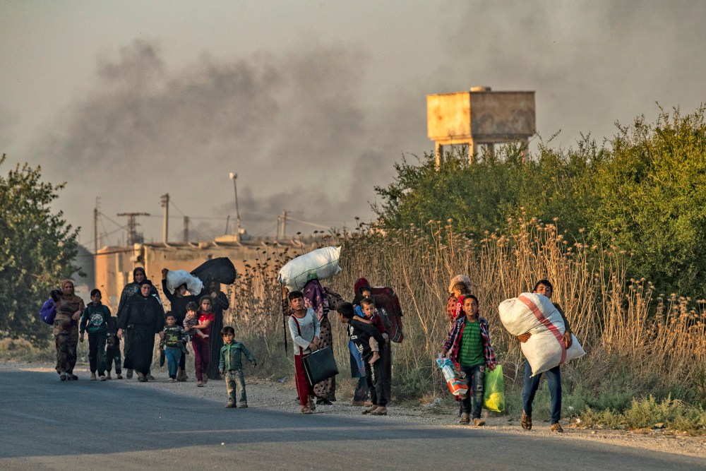 Syrian Arab and Kurdish civilians flee with their belongings amid Turkish bombardment on Syriau00e2u20acu2122s northeastern town of Ras al-Ain in the Hasakeh province along the Turkish border October 9, 2019. u00e2u20acu201d AFP pic 