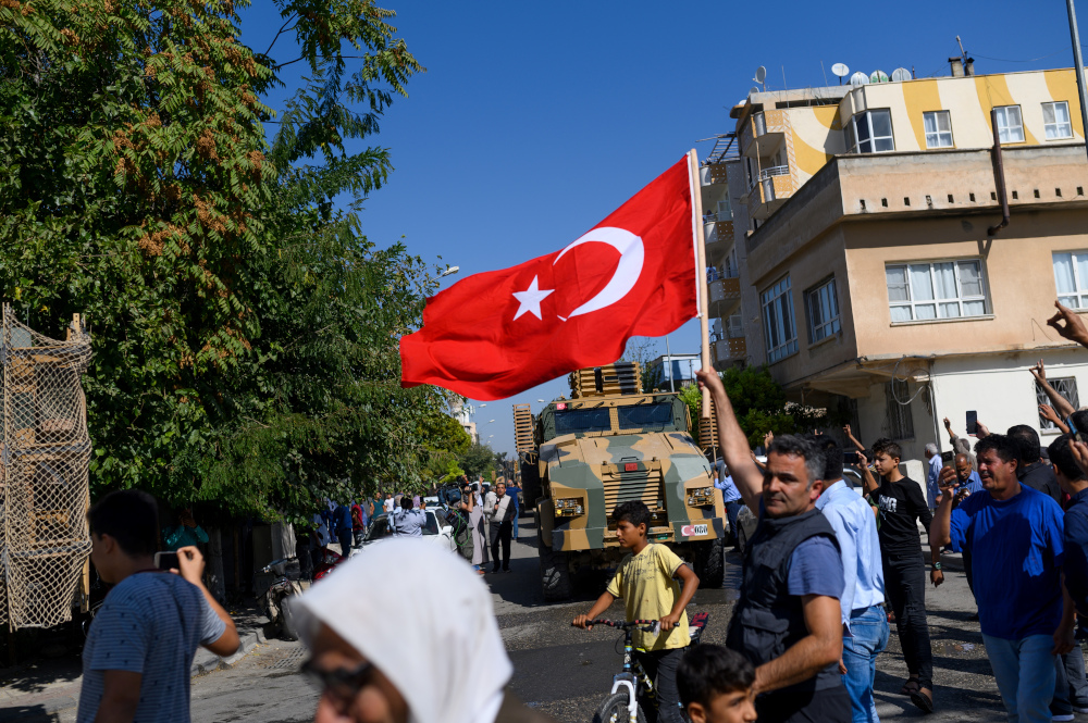 A man waves a Turkish flag as Turkey-backed Syrian opposition fighters head to Tel Abyad from the Turkish gate towards Syria in Akcakale in Sanliurfa province October 10, 2019. u00e2u20acu201d AFP pic 