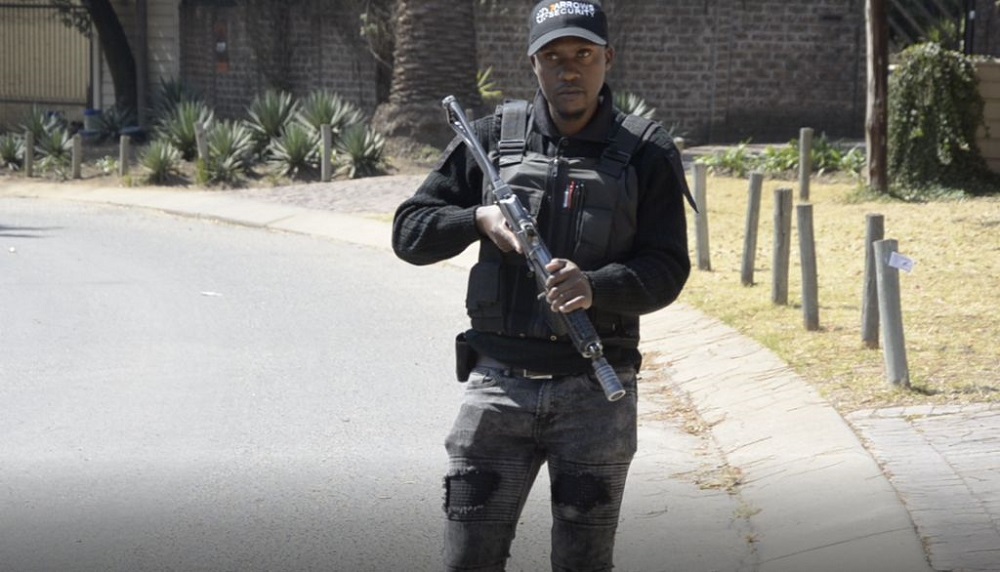A security guard leans against a wall in Sandton in Johannesburg, South Africa, 8 October 2019. u00e2u20acu201d Thomson Reuters Foundation pic