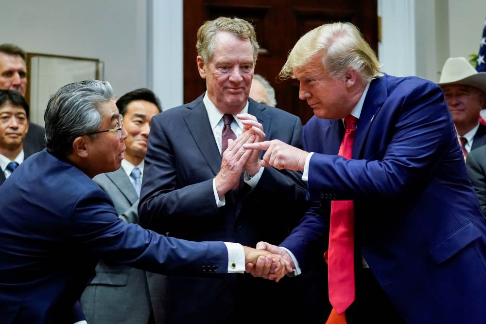US President Donald Trump shakes hands with Japan's ambassador to the United States Shinsuke Sugiyama in front of US Trade Representative Robert Lighthizer during a formal signing ceremony at the White House in Washington October 7, 2019. u00e2u20acu2022 Reuters pic