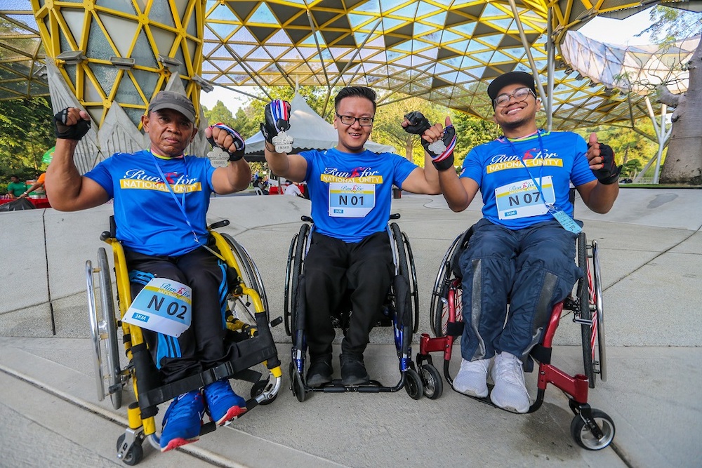 Winners of the Run for National Unity 2019 3km Special/OKU Wheelchair category Fuad Sanoesi (second place), Daniel Lee (first place) and Wan Effendi Sodikin (third place). ― Picture by Firdaus Latif 