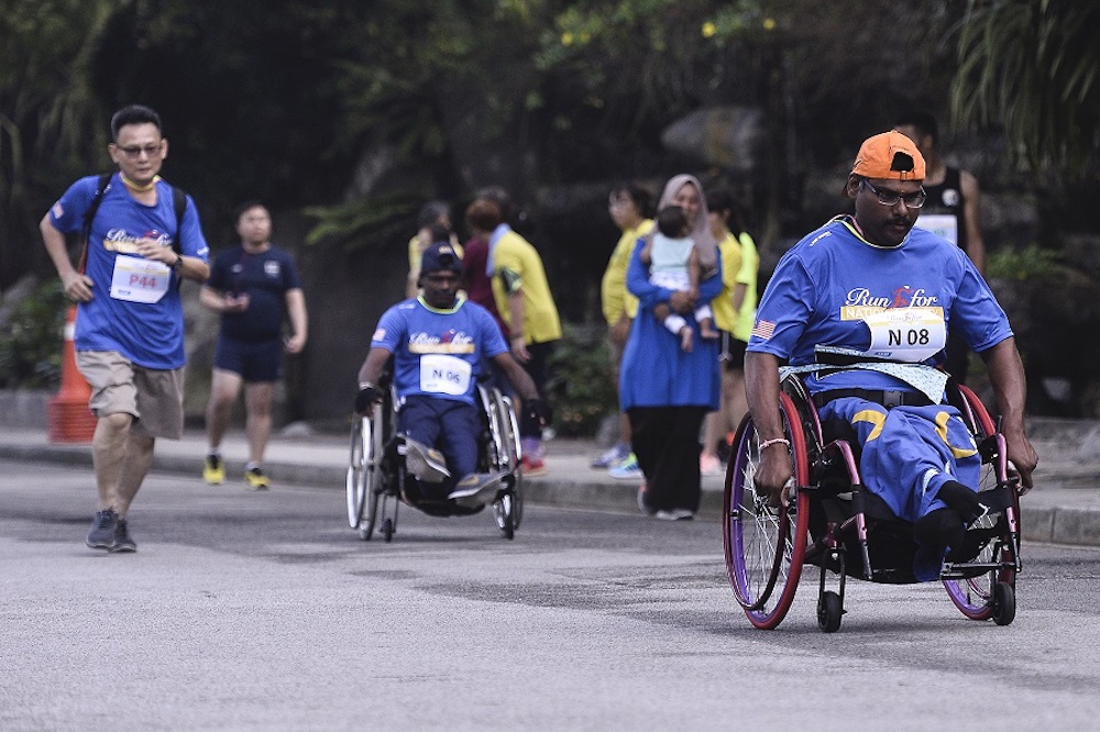 Rajoo Arumugam says the most difficult part of the run was keeping up with his highly competitive wheelchair-bound friends. ― Picture by Miera Zulyana