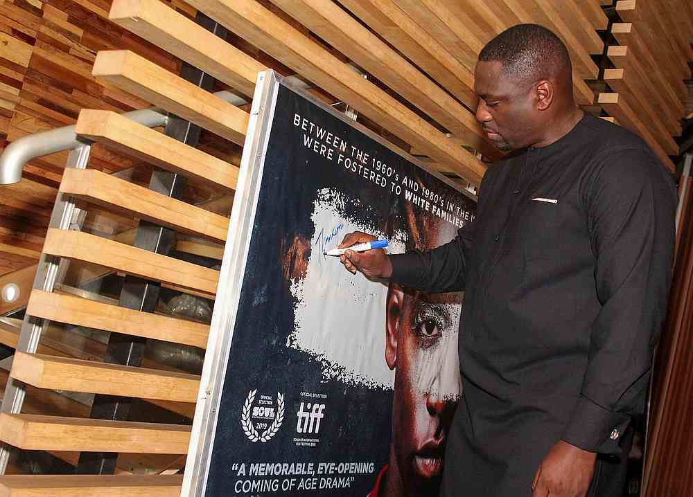 British-born Nigerian actor Adewale Akinnuoye-Agbaje signs a poster of his film 'Farming' during its premiere in Lagos, Nigeria October 21, 2019. u00e2u20acu201d Accelerate TV handout via Reuters