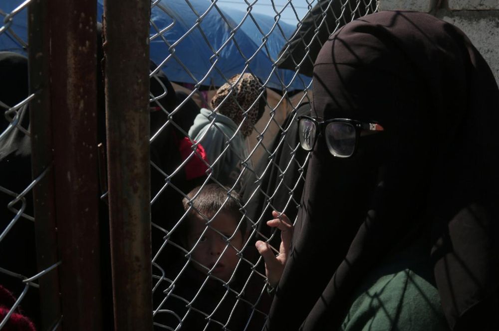 A woman looks through a chain linked fence at al-Hol displacement camp in Hasaka governorate, Syria, March 8, 2019. u00e2u20acu201d Reuters pic