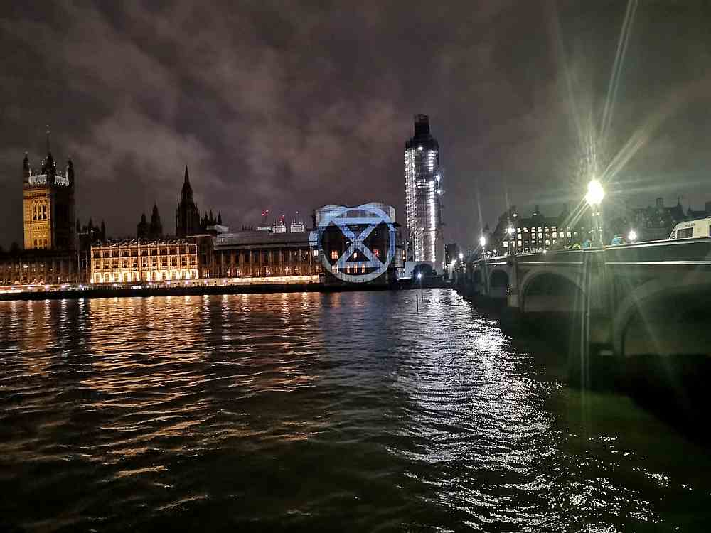 Climate change protest group Extinction Rebellion project an image onto the facade of UK's Houses of Parliament, Palace of Westminster, London October 7, 2019. u00e2u20acu201d Extinction Rebellion/social media pic via Reuters
