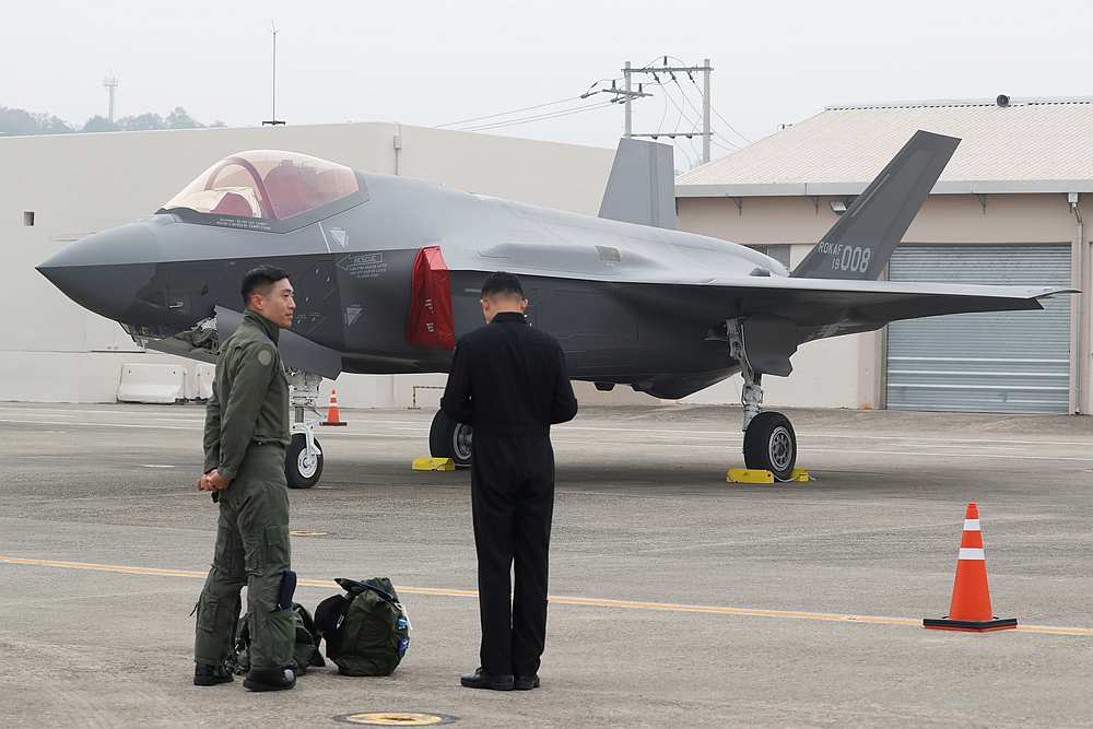 A South Korean fighter pilot (left) stands next to his F-35 stealth fighter during a ceremony to mark the 71st Armed Forces Day at the Air Force Base in Daegu October 1, 2019. u00e2u20acu201d Jeon Heon-kyun/Pool pic via Reuters