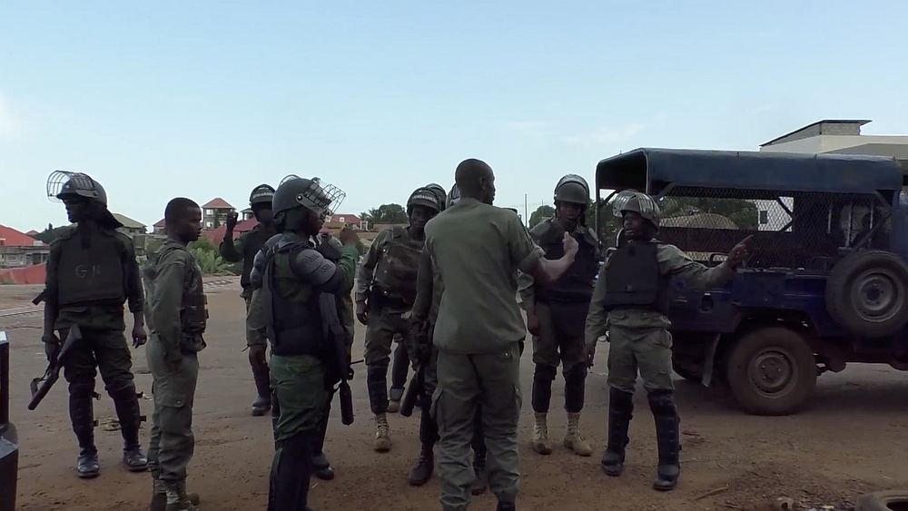Riot police gather near a main road blocked by protesters in Sonfonia District in Conakry, Guinea October 14, 2019. u00e2u20acu201d Video still image via Reuters