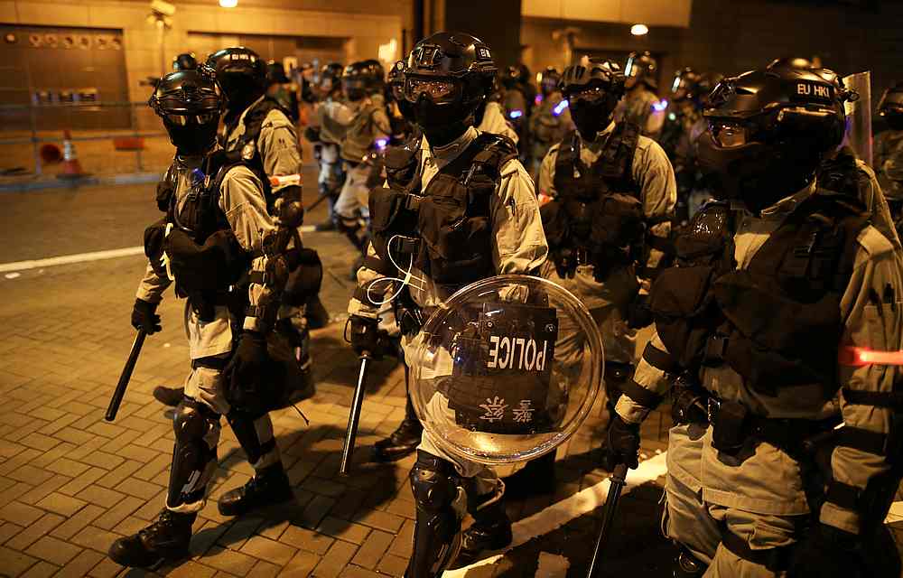 Riot police officers patrol the road during a protest in Hong Kong October 14, 2019. u00e2u20acu201d Reuters 