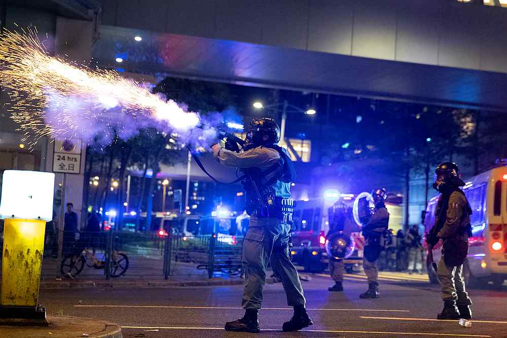 A riot police officer fires a tear gas canister toward anti-government protesters during a demonstration in the Tseung Kwan O residential area in Kowloon, Hong Kong October 7, 2019. u00e2u20acu201d Reuters pic