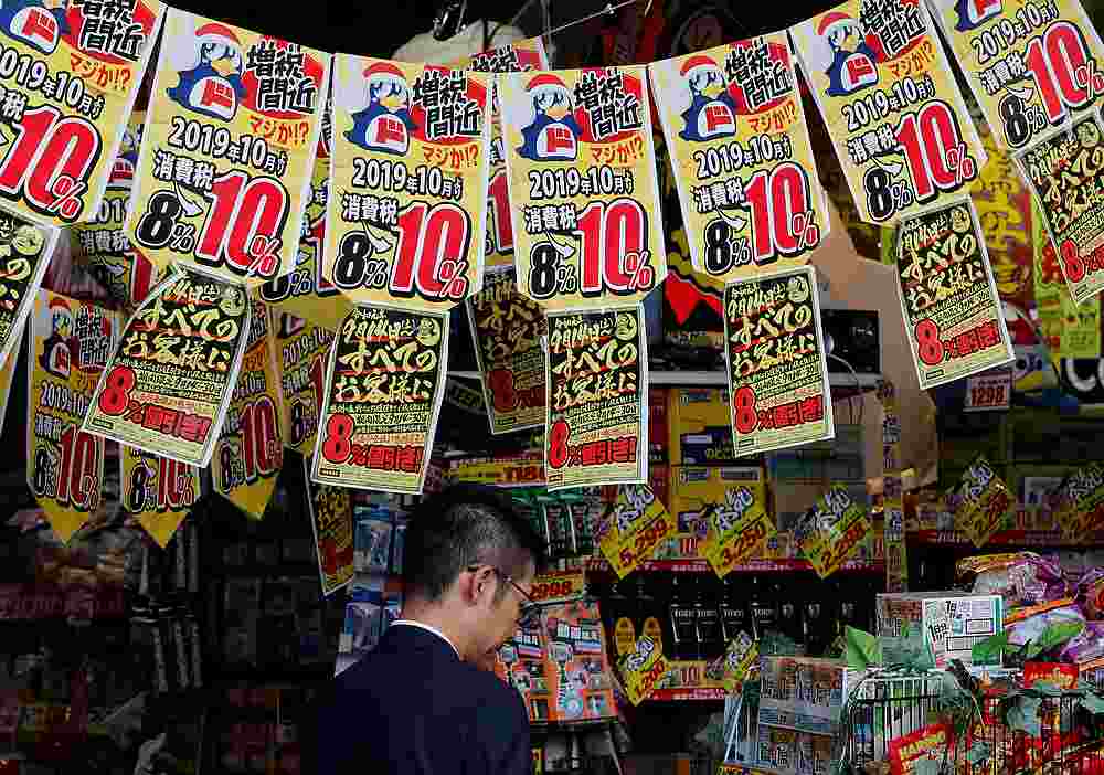 A man chooses goods underneath banners notifying the rise in the national sales tax at a store in Tokyo, Japan September 25, 2019. u00e2u20acu201d Reuters pic