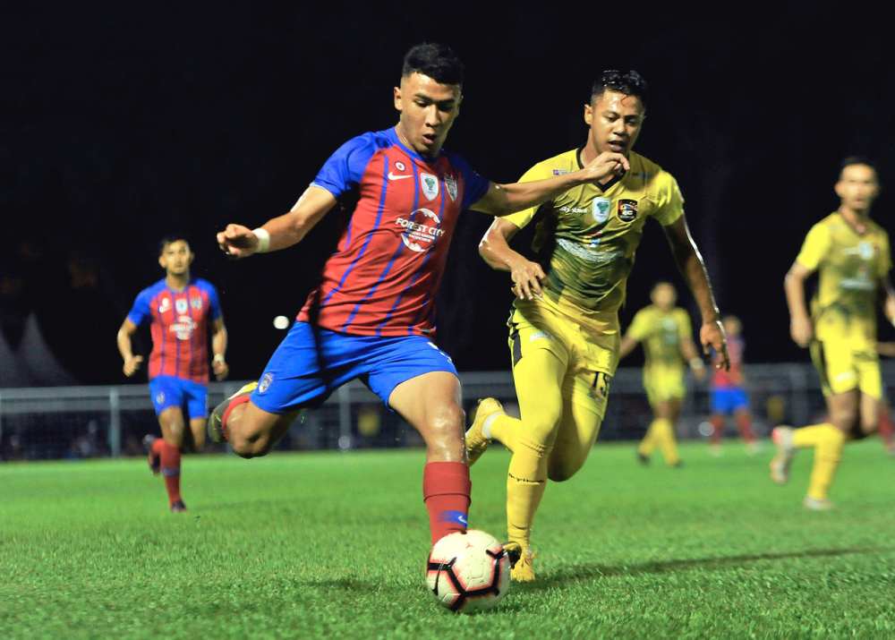 JDT IIu00e2u20acu2122s Muhammad Ramadhan Saifullah Usman (left) in action with UKM FC player Mohd Irwan Syazmin Wahab during the first leg final of the 2019 Challenge Cup in Johor Baru October 4, 2019. u00e2u20acu2022 Bernama pic