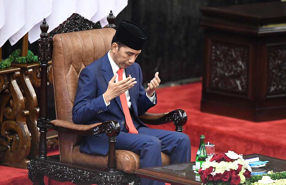 Indonesian President Joko Widodo gestures as he prays after taking his oath during his inauguration and a swearing-in ceremony in Jakarta October 20, 2019. u00e2u20acu201d Antara Foto/Akbar Nugroho Gumay pic via Reuters