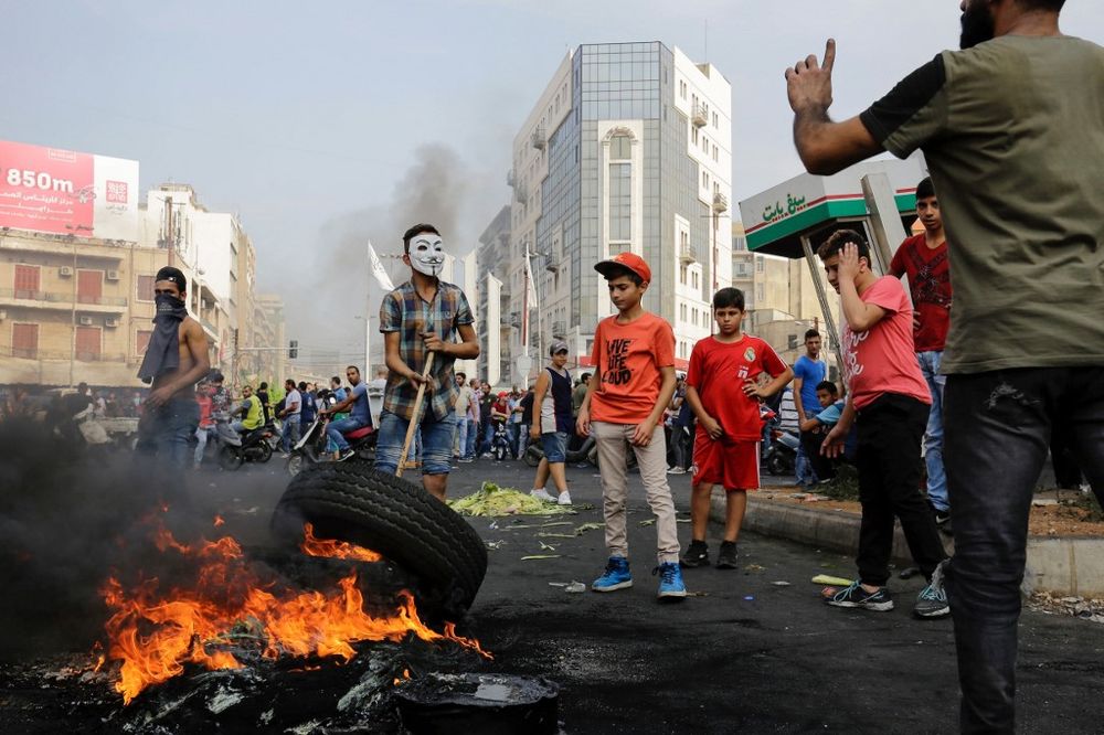 Lebanese demonstrators burn tires during a protest against dire economic conditions, on October 18, 2019 in the northern port city of Tripoli The Lebanese government faced calls to resign. u00e2u20acu201d AFP pic