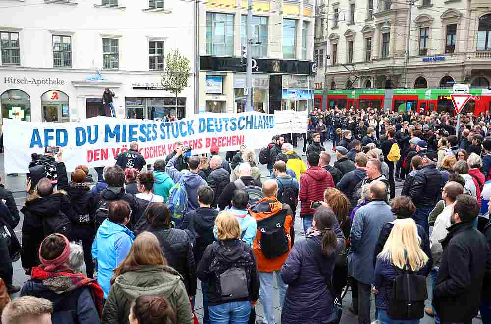 A right-wing protester tries to speak during a gathering in Halle, Germany October 11, 2019, after two people were killed in a shooting. The banner reads 'AFD you lousy piece of Germany.'  u00e2u20acu201d Reuters pic