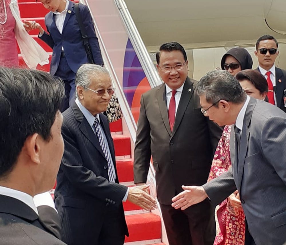 Tun Dr Mahathir Mohamad is received by Foreign Minister Datuk Saifuddin Abdullah upon his arrival at Halim Perdanakusuma International Airport in Jakarta October 20, 2019. u00e2u20acu201d Picture via Twitter/Bernamadotcom