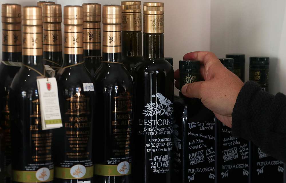 A consumer picks up a bottle of extra virgin olive oil in Fundacion Patrocinio Comunal Olivarero shop in Madrid October 3, 2019. u00e2u20acu201d Reuters pic