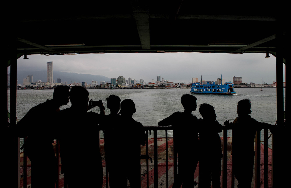 Passengers take in the view aboard the Penang Ferry as it makes a crossing from Penang island to the mainland October 3, 2019. u00e2u20acu201d Picture by Sayuti Zainudin