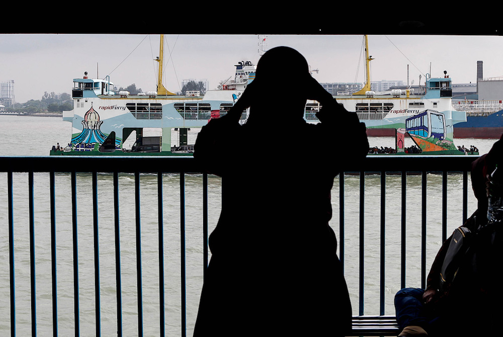 Passengers take in the view aboard the Penang Ferry as it makes a crossing from Penang island to the mainland October 3, 2019. u00e2u20acu201d Picture by Sayuti Zainudin