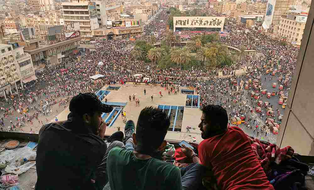 Demonstrators sit on top of a building and watch a protest over corruption, lack of jobs, and poor services, in Baghdad, Iraq October 28, 2019. u00e2u20acu201d Reuters pic
