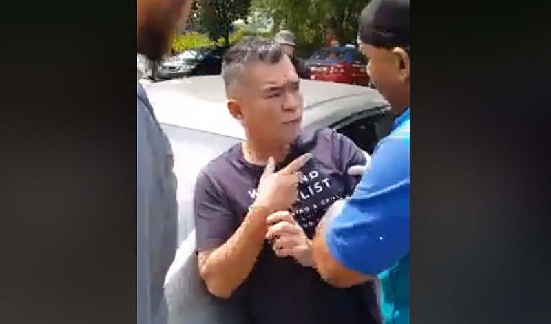 MPSJ council workers confront Koh after her persistently tried to stop them from capturing ‘Puchong.’ — Screengrab via Facebook/We Are Malaysian