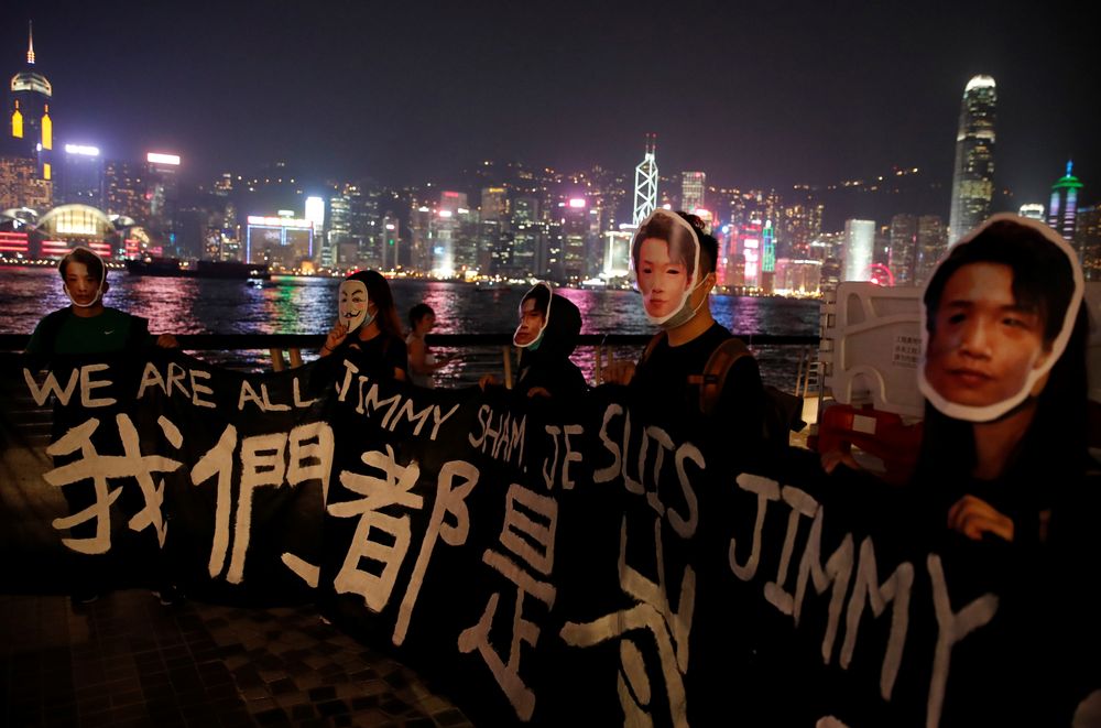 People wearing masks depicting Jimmy Sham hold a banner during an anti-government protest in Hong Kong, China, October 18, 2019. u00e2u20acu201d Reuters pic