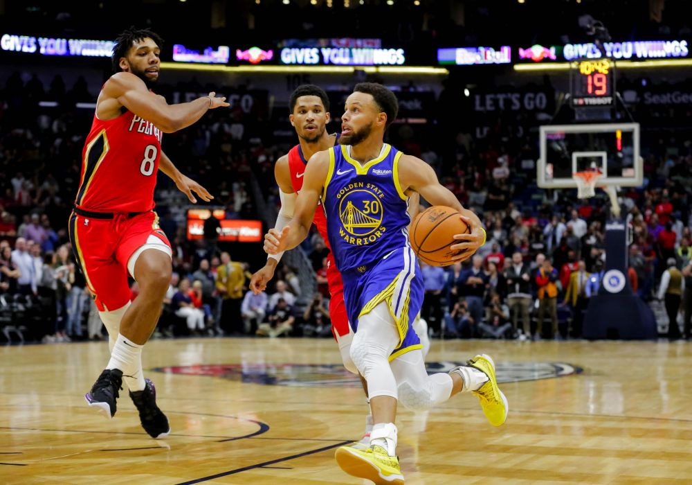 Golden State Warriors guard Stephen Curry (30) drives past New Orleans Pelicans guard Josh Hart (3) and centre Jahlil Okafor (8) during the first quarter at the Smoothie King Centre. u00e2u20acu201d Reuters pic