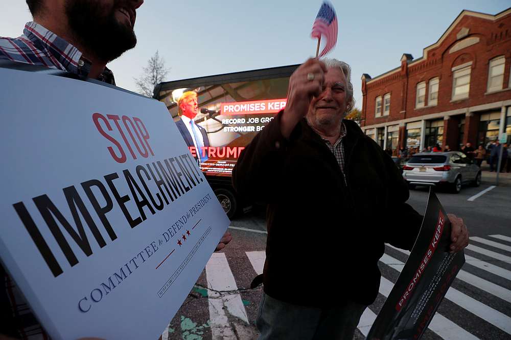 Supporters of US President Donald Trump carry 'Stop Impeachment' signs outside a campaign town hall meeting in Newport, New Hampshire October 24, 2019. u00e2u20acu201d Reuters pic