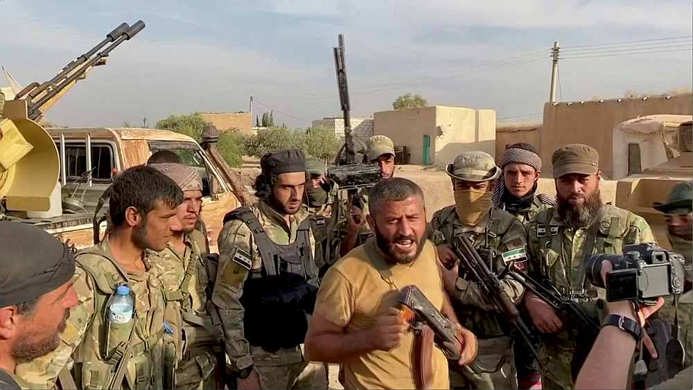 A Syrian rebel fighter declares the liberation of Mehrabli village from the Syrian Democratic Forces (SDF) near Tal Abyad, Syria October 11 2019. u00e2u20acu201d Reuters TV still image