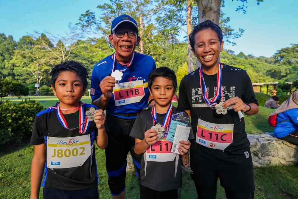 Fazliana Ismail and her twin nephews Adam Danish (left) and Adam Daniel with their dad Raiei Mahidin. ―  Picture by Firdaus Latif