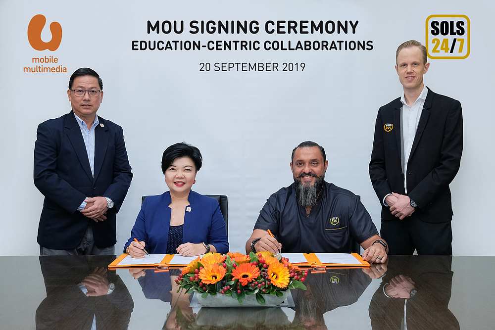 U Mobile Multimedia director Jasmine Lee and SOLS 24/7 founder Raj Ridvan Singh sign the MoU. Looking on are U Mobile chief network officer Too Tian Jen (left) and SOLS Smart managing director Tim Spijker. — Picture courtesy of U Mobile