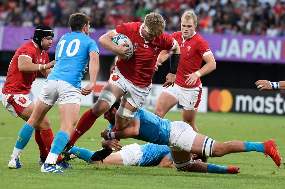 Walesu00e2u20acu2122 number 8 Aaron Wainwright (centre) is tackled during the Japan 2019 Rugby World Cup Pool D match between Wales and Uruguay at the Kumamoto Stadium in Kumamoto, October 13, 2019. u00e2u20acu201d AFP pic