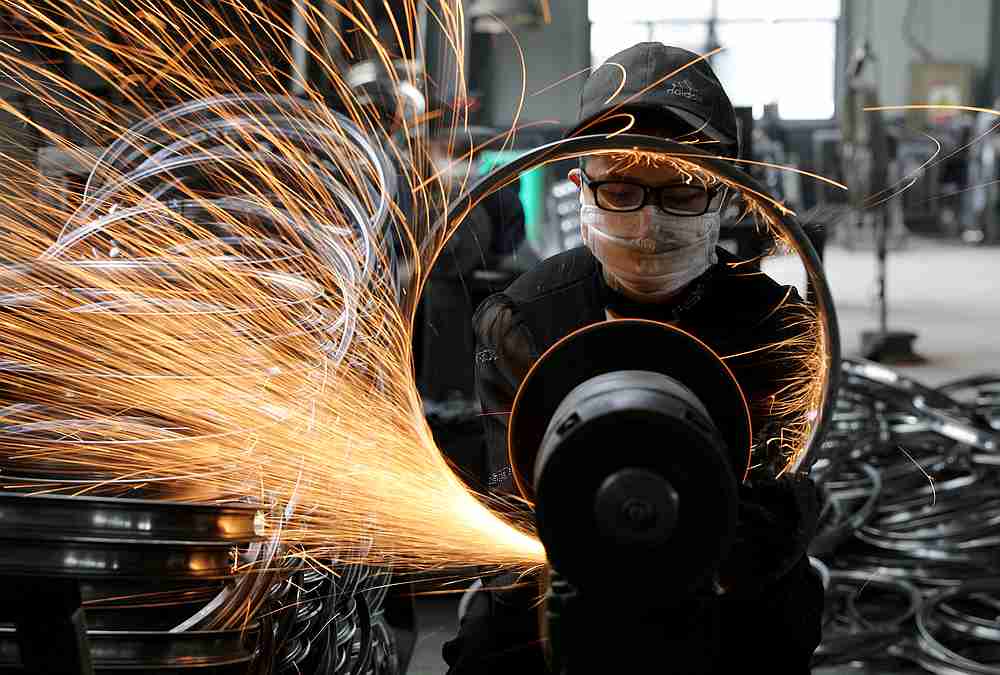 A worker welds a bicycle steel rim at a factory manufacturing sports equipment in Hangzhou, Zhejiang province, China September 2, 2019. u00e2u20acu201d China Daily pic via Reuters