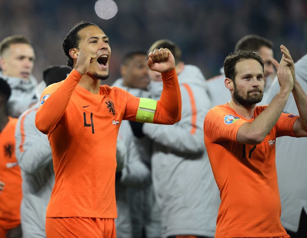 Netherlandsu00e2u20acu2122 Virgil van Dijk and Daley Blind celebrate on the pitch after the Euro 2020 qualification match with Northern Ireland at Windsor Park in Belfast November 16, 2019. u00e2u20acu201d AFP pic