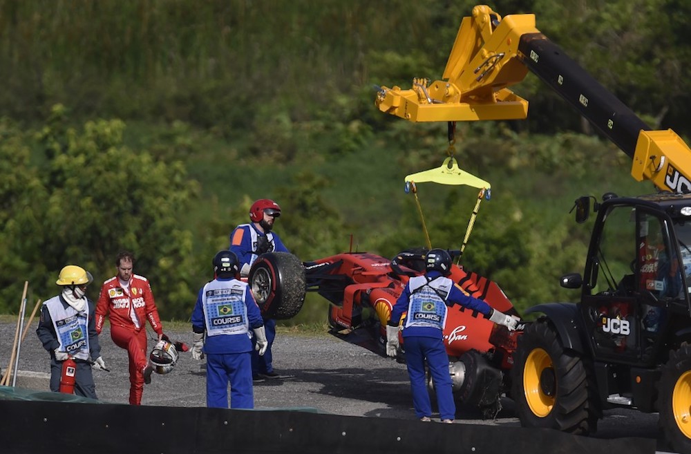Ferrariu00e2u20acu2122s Sebastian Vettel reacts while a crane lifts his car after a crash during the Brazilian Grand Prix at the Interlagos racetrack in Sao Paulo November 17, 2019. u00e2u20acu201d AFP pic