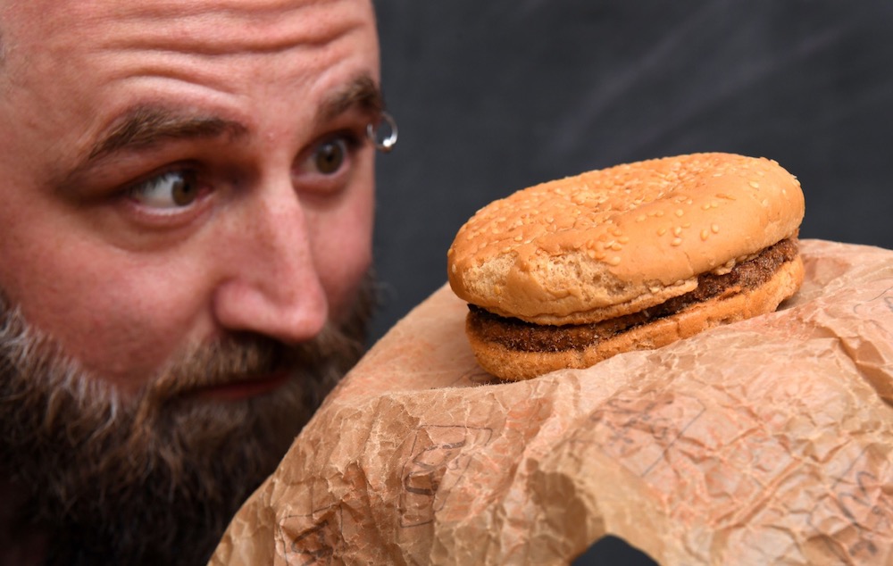 Casey Dean inspects a McDonald's burger bought in 1995 and kept in an Australian shed for years which has never decomposed in Melbourne November 7, 2019. u00e2u20acu201d AFP pic