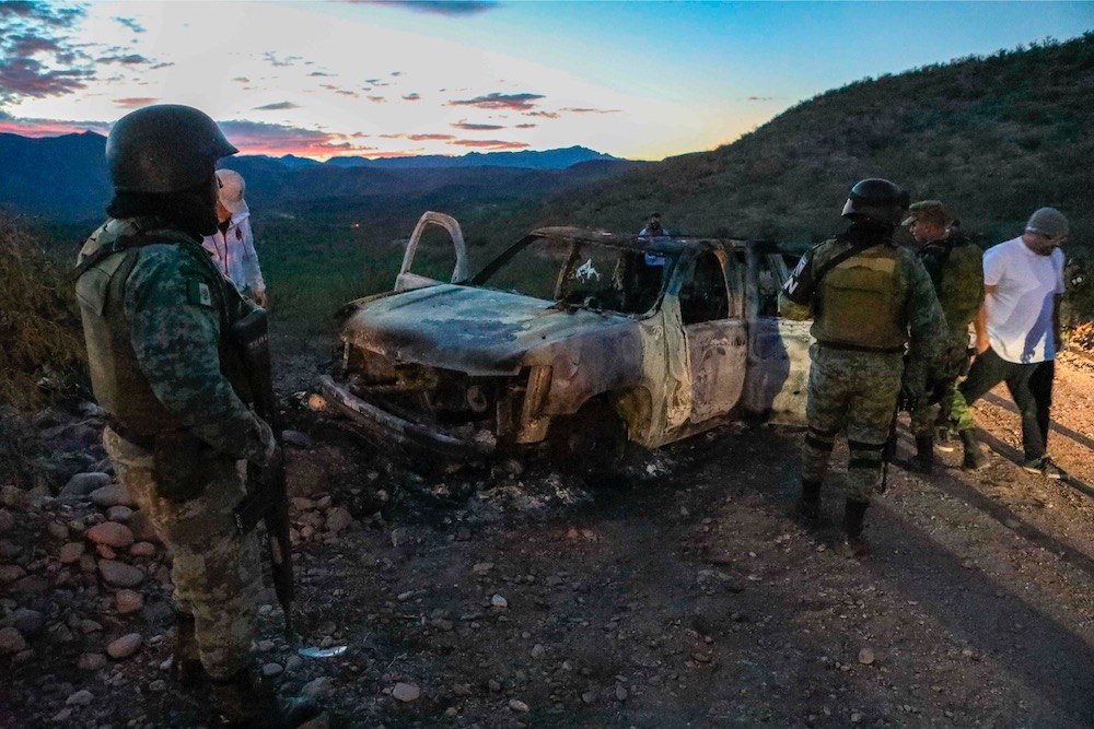 People stand near the burned car where part of the nine murdered members of the family were killed and burned during an ambush in Bavispe, Sonora mountains, Mexico, on November 5, 2019. u00e2u20acu201d AFP pic