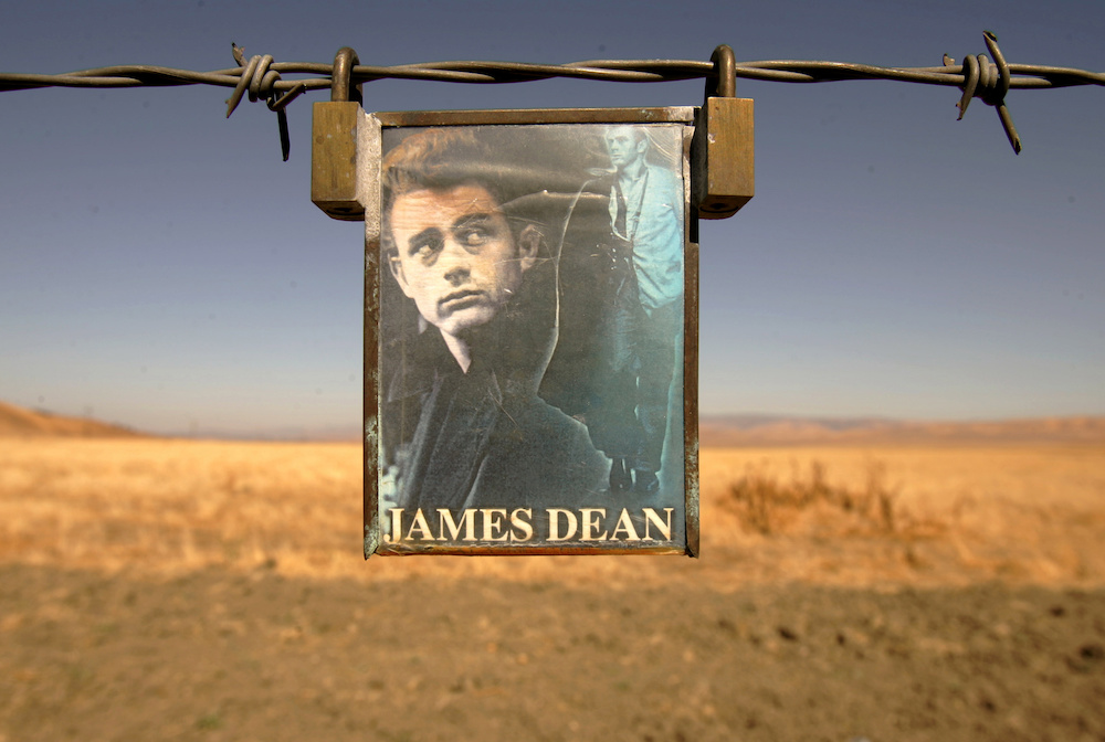 A portrait of US actor James Dean hangs from a fence near the intersection of Highways 46 and 41 near Cholame, California September 30, 2005. u00e2u20acu201d Reuters pic