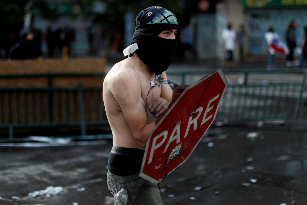A demonstrator uses a stop sign as protection during a protest against Chile's government in Santiago October 29, 2019. u00e2u20acu201d Reuters pic