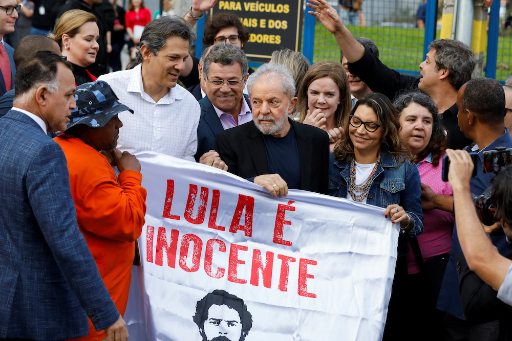 Former Brazilian President Luiz Inacio Lula da Silva holds a banner reading u00e2u20acu02dcLula is innocentu00e2u20acu2122 after being released from prison, in Curitiba, Brazil November 8, 2019. u00e2u20acu201d Reuters pic