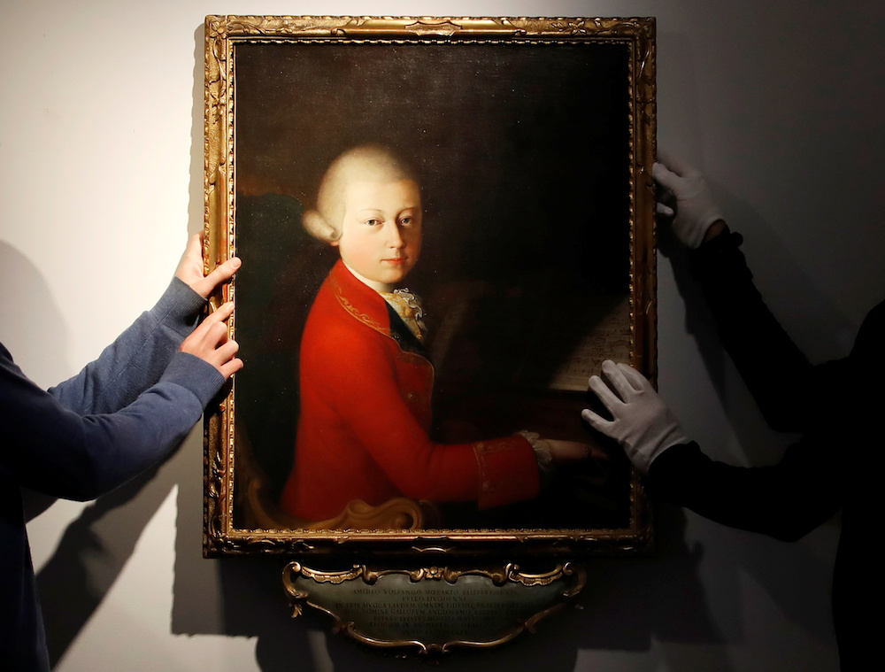 Workers install a portrait due to be sold at auction by Christie's on November 27 which depicts composer Wolfgang Amadeus Mozart as a teenager, attributed to Veronese master Gaimbettino Cignaroli, in Paris November 12, 2019. u00e2u20acu201d Reuters pic