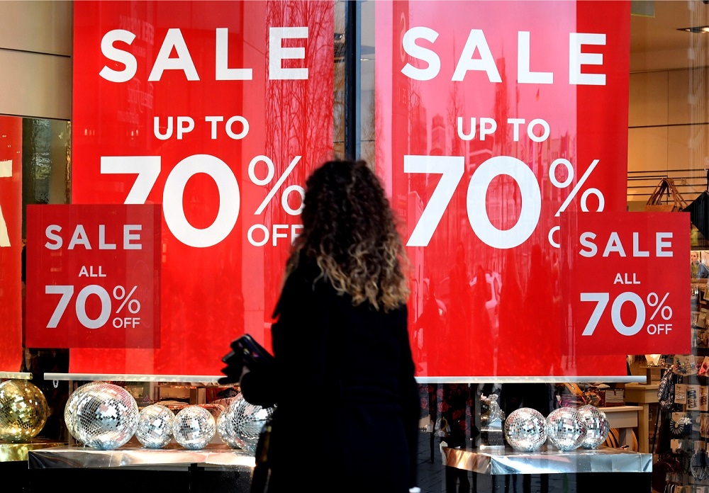 A woman passes sale signs in a shop window in downtown Hamburg January 25, 2018. u00e2u20acu201d Reuters pic